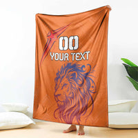Orange personalized football blanket with lion head, star logo, and “YOUR TEXT”