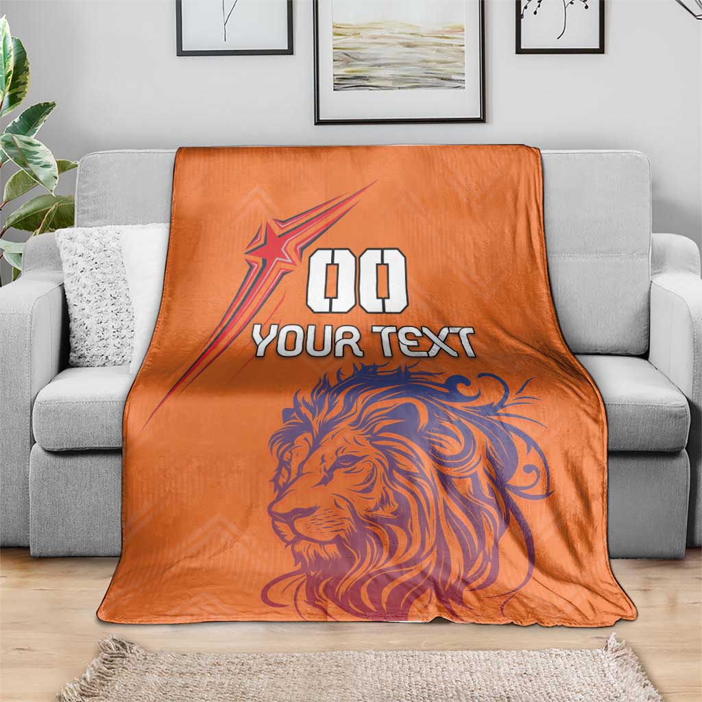 Orange football blanket draped over a sofa with lion and star plus “YOUR TEXT”