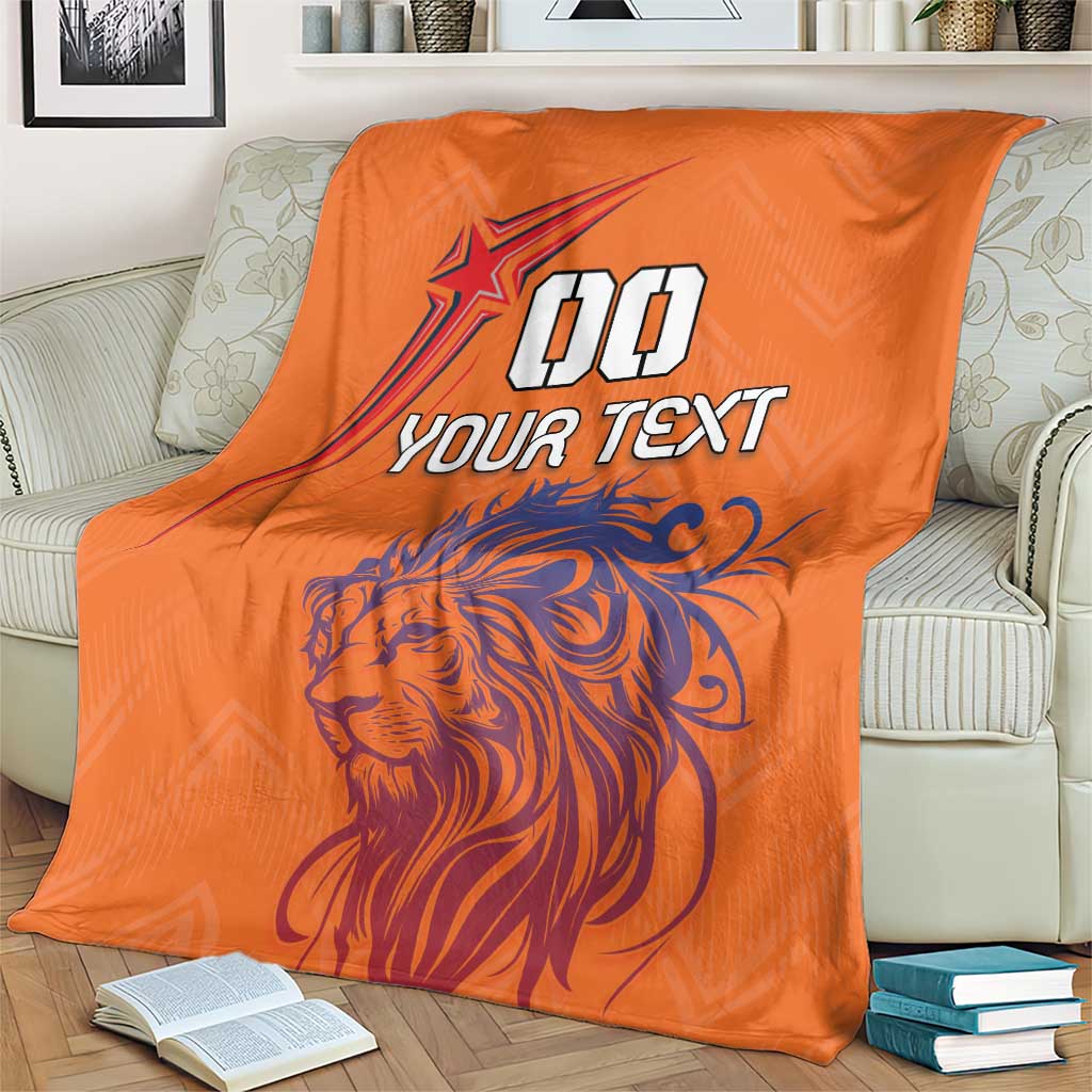 Orange throw blanket featuring lion face and star with “YOUR TEXT” text