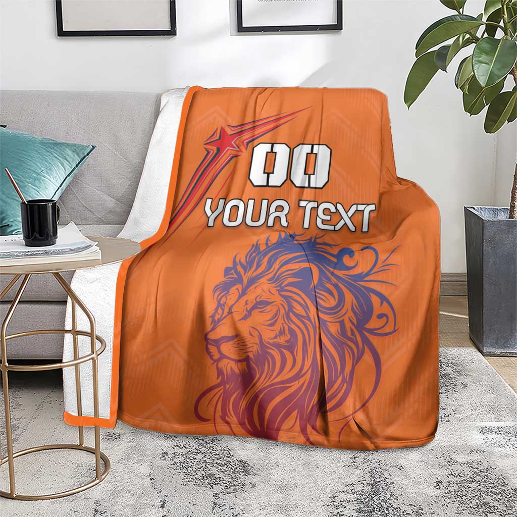 Orange sports blanket with lion illustration, star emblem, and “YOUR TEXT”