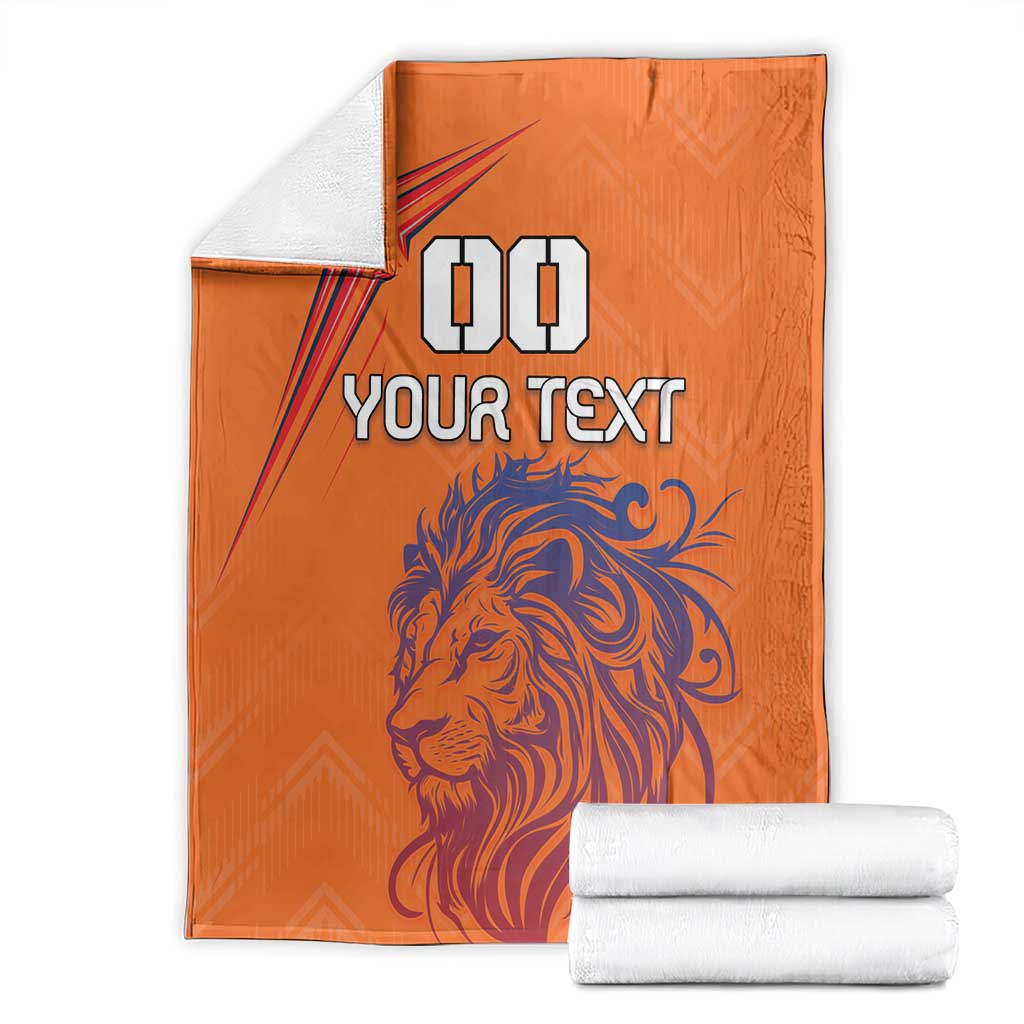 Orange custom blanket with lion graphic and star, paired with folded white towels