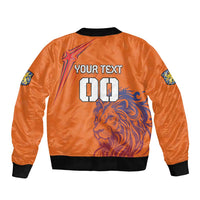 Orange bomber jacket with black ribbed hem and lion back graphic, plus custom number