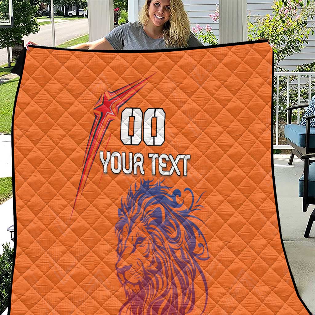 Orange quilt with diamond stitching, blue lion graphic, and star with 00, plus 'YOUR TEXT'