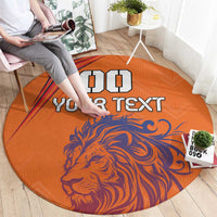 Orange round carpet with blue lion face and black 'Your Text' text, wide view