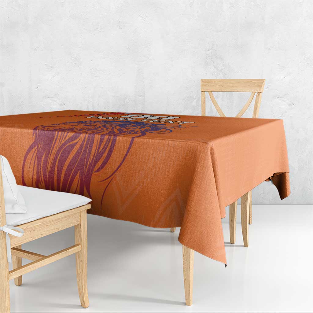 Orange printed tablecloth with lion-themed graphic running across the surface