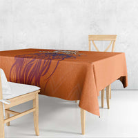 Orange printed tablecloth with lion-themed graphic running across the surface