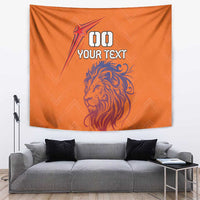 Orange tapestry featuring lion head, starburst, and 00 YOUR TEXT