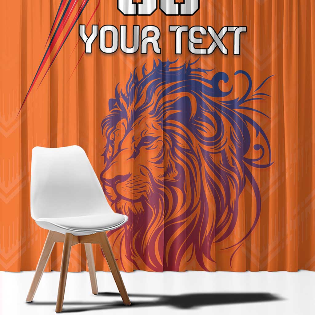 Orange curtain close-up with blue lion design and bold custom text