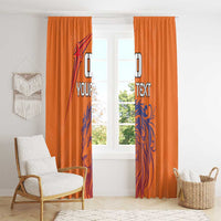 Orange window curtains with blue lion graphic and custom text, hanging tall