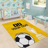 Yellow soccer area rug with soccer ball, trophy, and slogan print in kids room