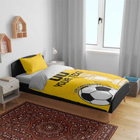 Yellow football bedding set on bed, duvet shows soccer ball and trophy graphics