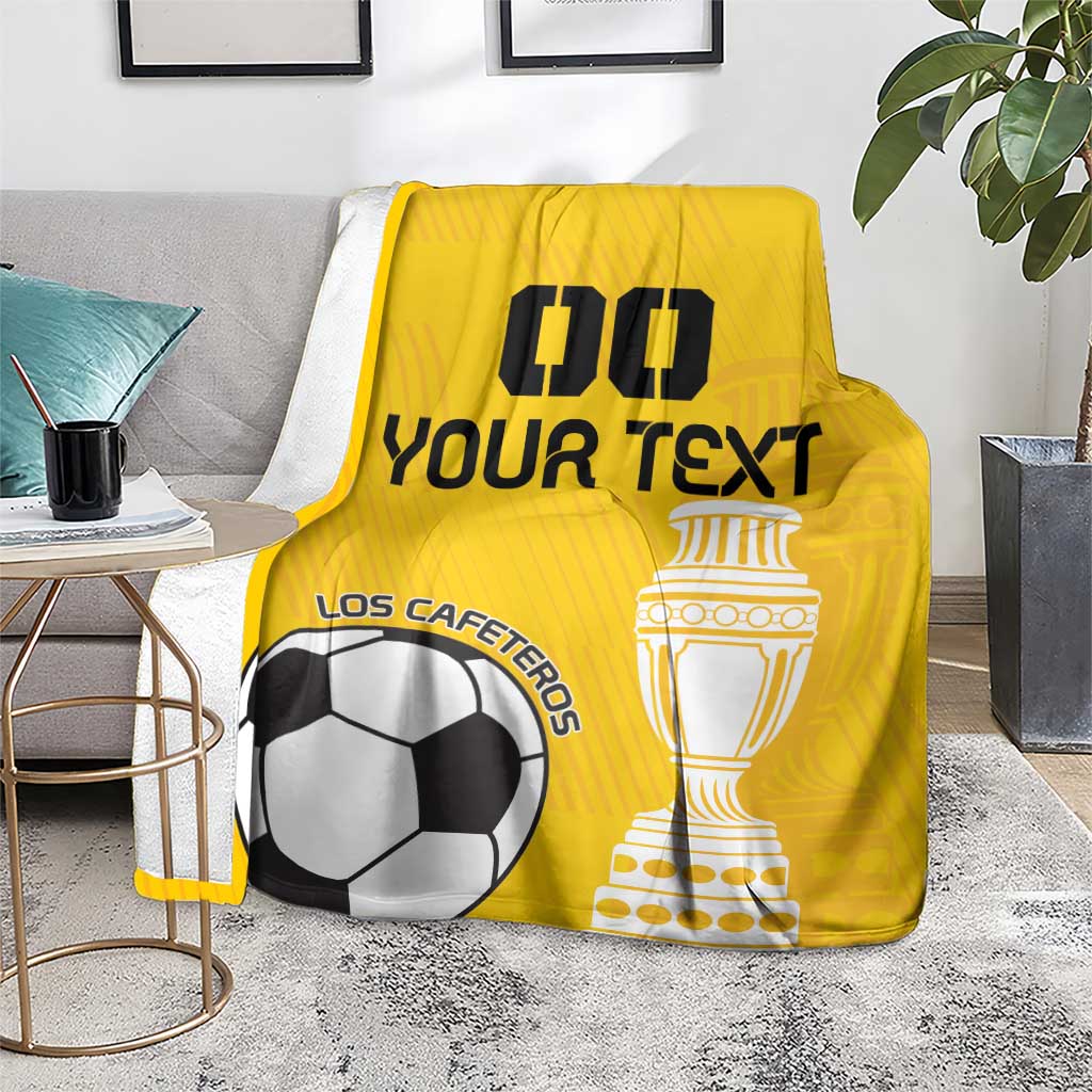 Yellow custom football blanket draped on a sofa with trophy and soccer ball design