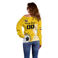 Yellow off-shoulder football sweater with back text and soccer print, side view
