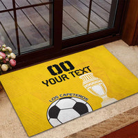 Yellow custom rubber football doormat with trophy, “Your Text,” and “Los Cafeteros” soccer ball.