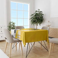 Yellow football tablecloth draped over dining table with soccer ball artwork