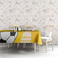 Yellow football tablecloth on dining table with soccer ball and trophy print