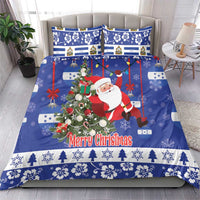 Blue Christmas bedding set on sofa with Santa, wreath, red accents, and “Merry Christmas”