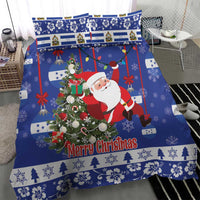 Blue Christmas bedding set with Santa near a wreath, “Merry Christmas” and snowy borders