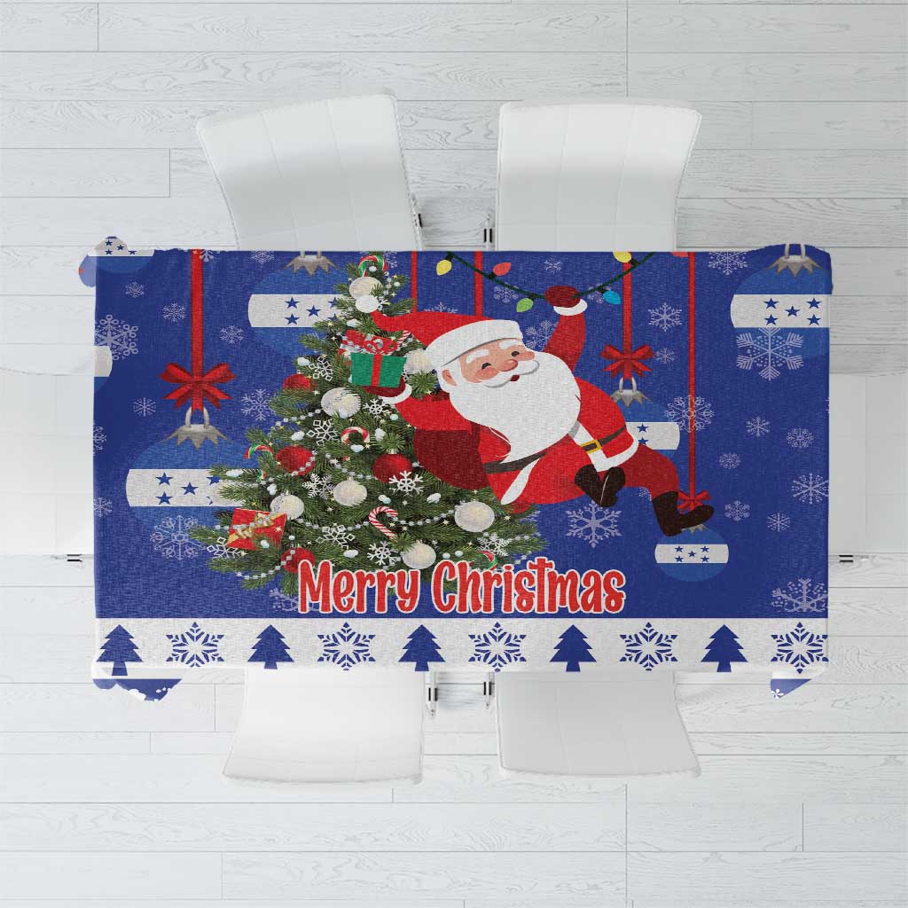 Blue Christmas tablecloth with Santa, greenery, and 'Merry Christmas' text