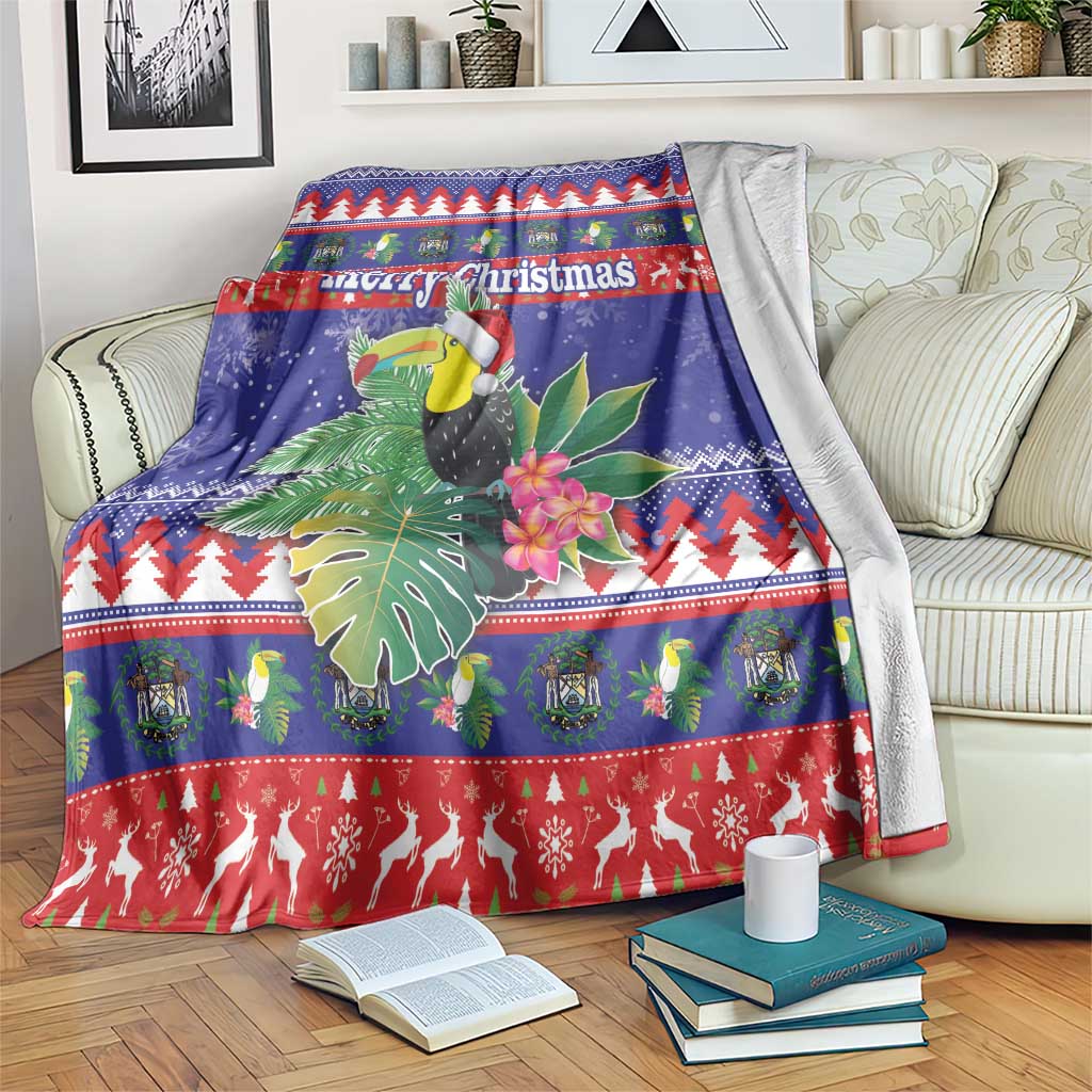 Blue Christmas blanket with toucan, tropical leaves, flowers, and Merry Christmas text
