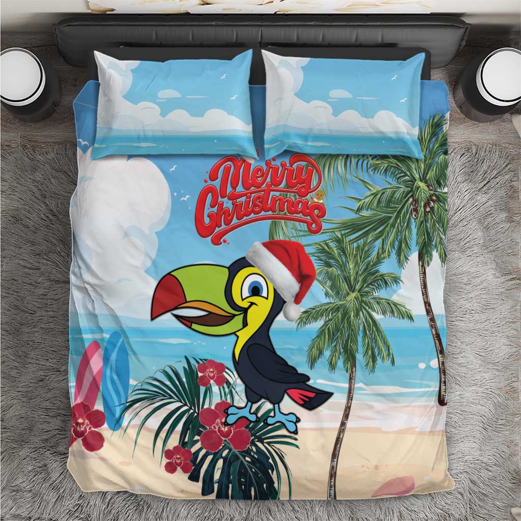 Blue holiday bedding set with toucan wearing Santa hat and tropical palm print, plus “Merry Christmas”