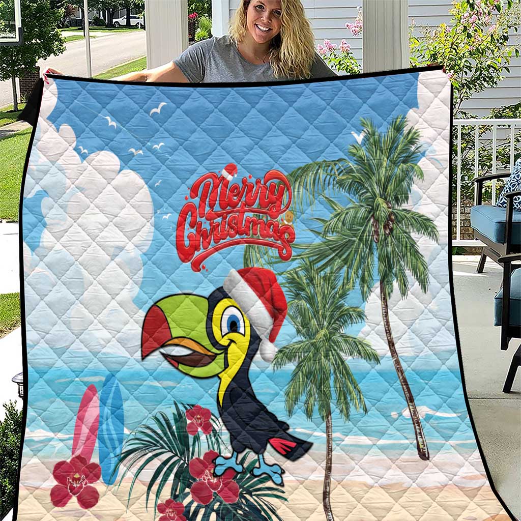 Blue and white Christmas quilt with toucan, palm trees, “Merry Christmas” text, black edge