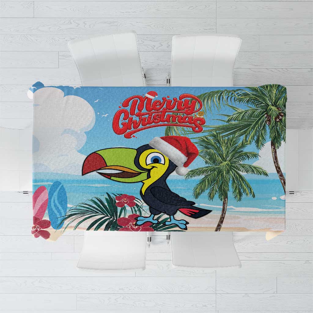 Christmas tablecloth with toucan, palm leaves, and "Merry Christmas" text, blue and cream.