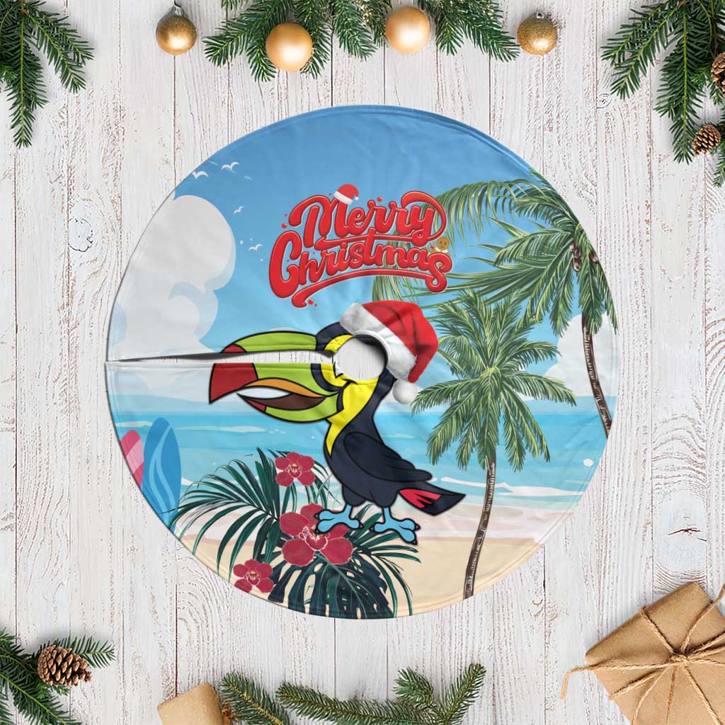 Round blue tree skirt with white fringe and Merry Christmas toucan-and-palm graphic