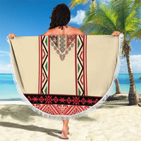 Beige round beach blanket with red embroidered stripe motif and white fringed hem