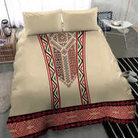 Beige bedding set showing red geometric embroidered border across the duvet hem