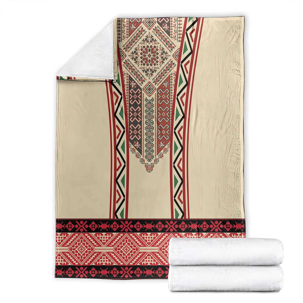 Beige blanket with red and black embroidered vertical motif and border stripe.