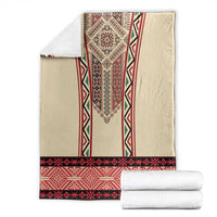 Beige blanket with red and black embroidered vertical motif and border stripe.