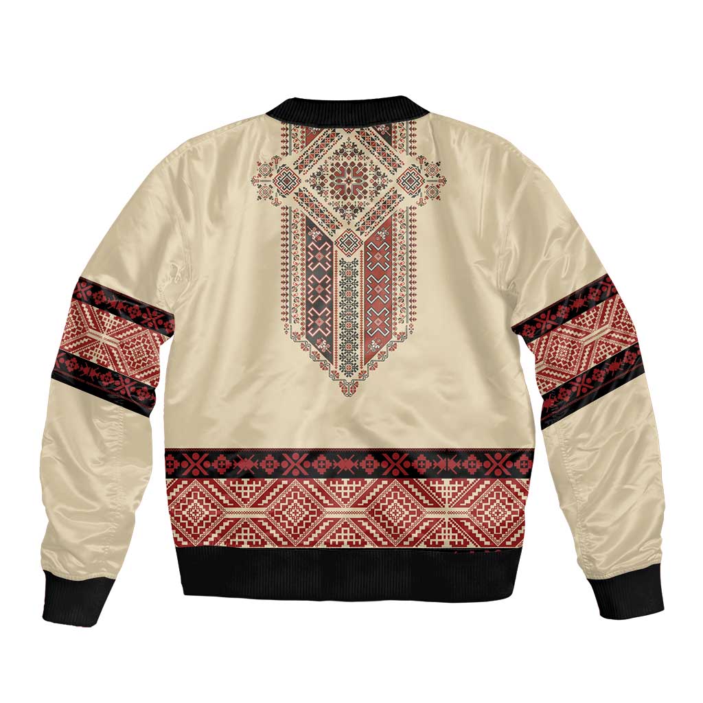 Beige bomber jacket with red geometric embroidery and black ribbed cuffs