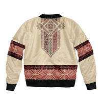 Beige bomber jacket with red geometric embroidery and black ribbed cuffs