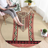 Beige round rug with red, black, and green embroidered stripe bands