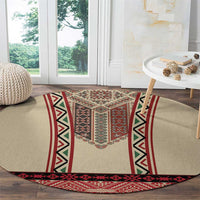 Beige round carpet with red border stripes and dark geometric embroidery panel