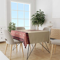 Beige tablecloth with red geometric embroidery border and dark patterned stripe