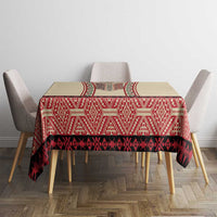 Beige tablecloth with red tribal-style pattern and black decorative band