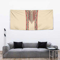Beige tapestry with red vertical embroidery stripe above gray sofa