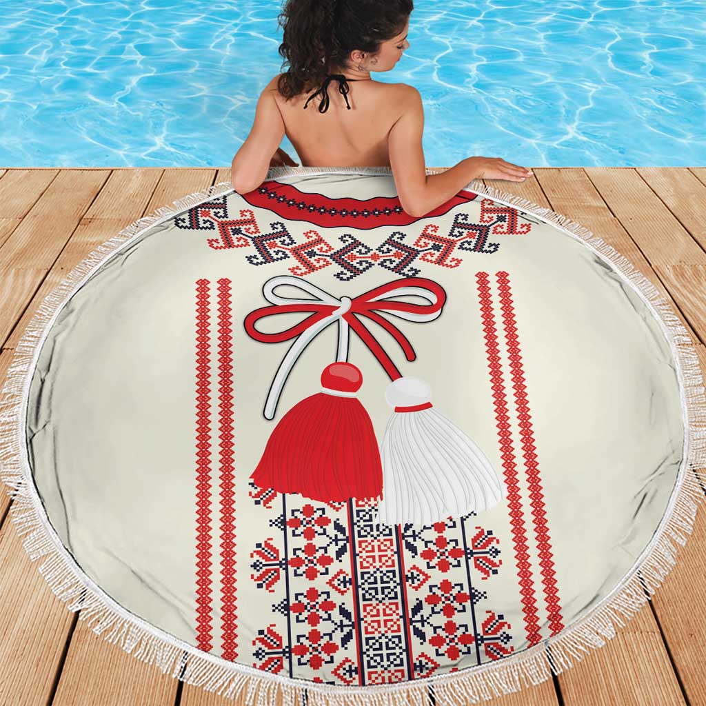 Round beach blanket on wooden dock, white with red vertical folk stripes and motifs