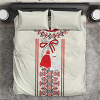 Light beige bedding set with centered Romanian folk girl illustration and red border trim