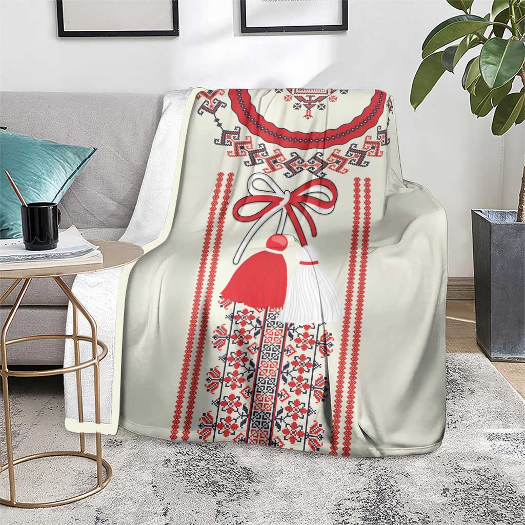 Light Romanian folklore blanket with red-dressed figure and patterned hem border, draped on chair