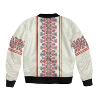 Beige bomber jacket with red/white folk pattern stripe panels, black rib hem and cuffs