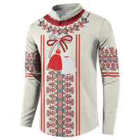 Beige long-sleeve sweatshirt with red, white, and blue folk motif panel and ribbon bow graphic