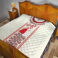 White quilted bed throw with red-and-black Romanian dress strip pattern across center