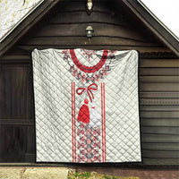 White quilt with quilted diamond texture and red Romanian folk dress panel with trim