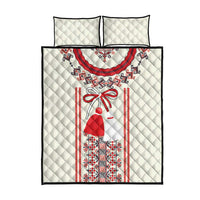 Cream quilt bed set with red and blue central folk motif and two matching pillows
