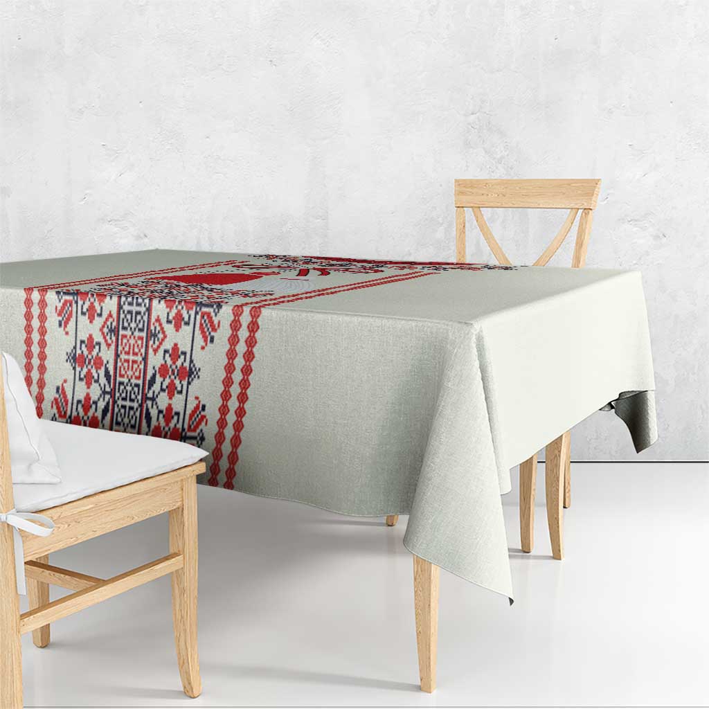 Beige tablecloth corner detail with red folk motif strip