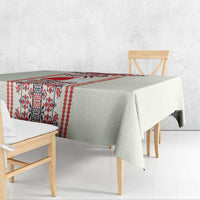 Beige tablecloth corner detail with red folk motif strip