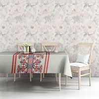 Beige tablecloth with red border and cross-stitch folk motif panels